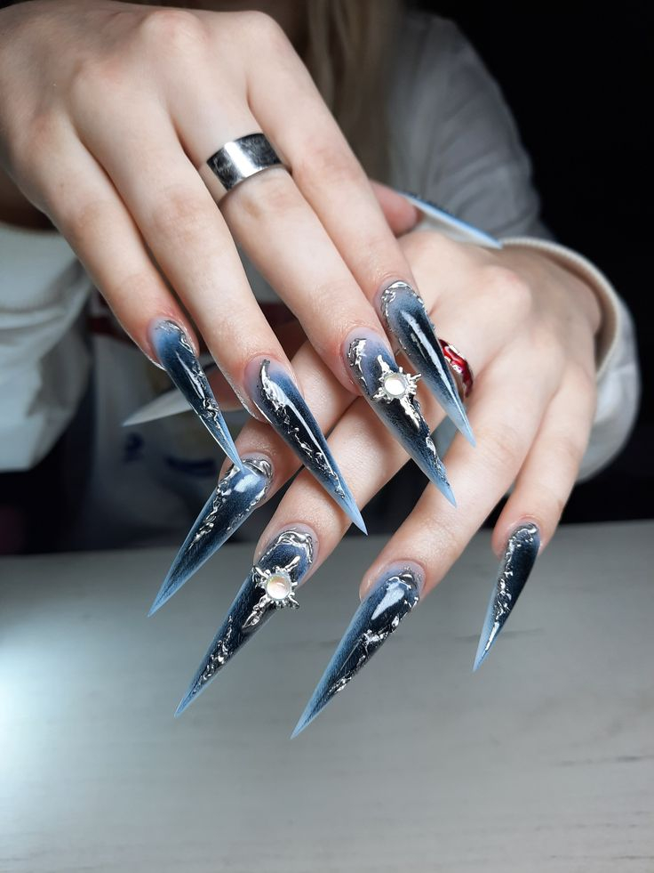 Dramatic dark blue ombre stiletto nails with silver chrome borders and cross charm