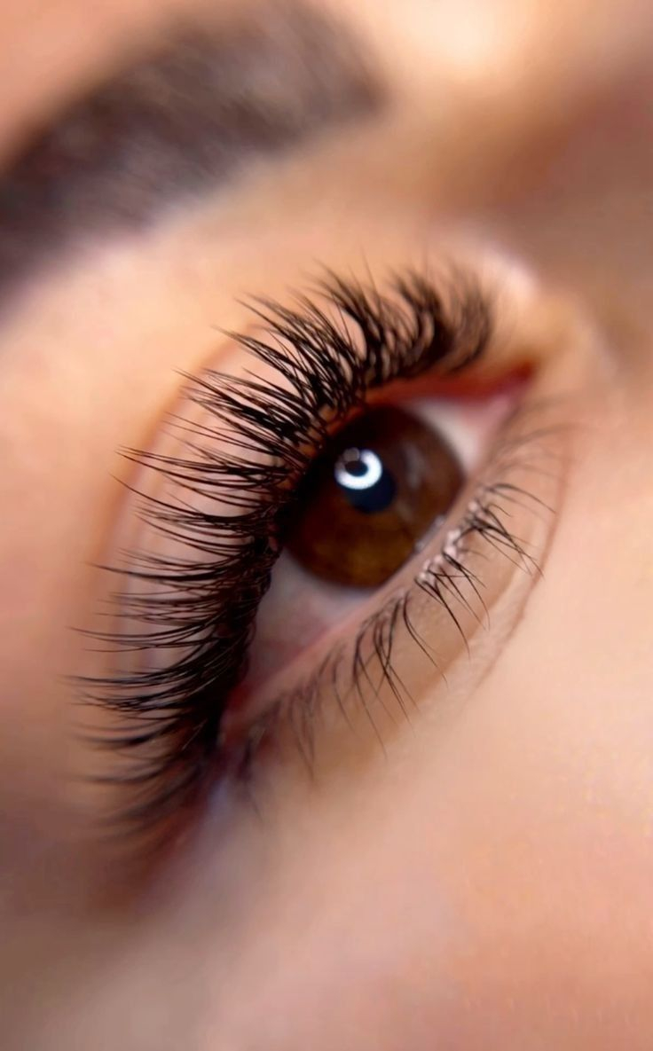 Close up of natural classic full set lash extensions on hazel eye