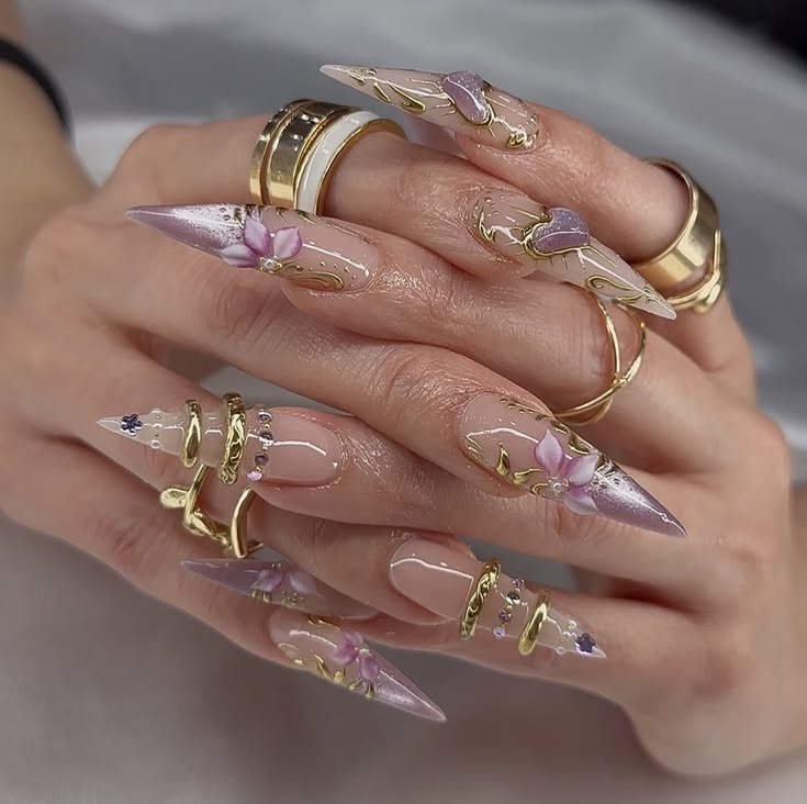 Pastel purple stiletto gel nails with hand-painted flowers and 3D gold wire swirls