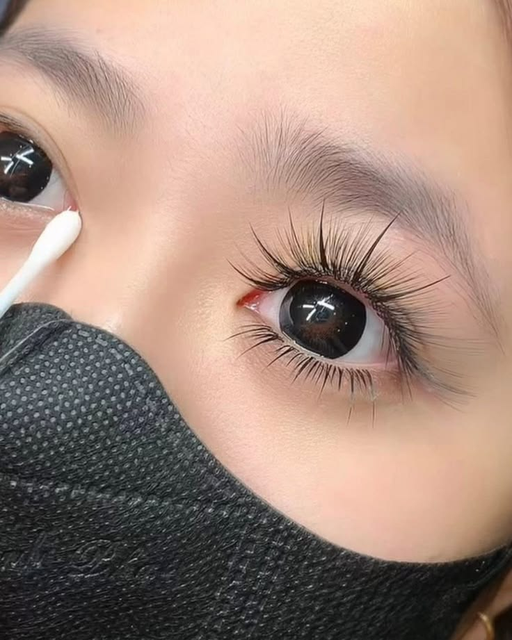 Gentle eye cleaning with cotton swab after hybrid lash extensions